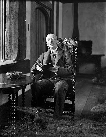 Nathaniel Lloyd reading at Great Dixter, photographed in March 1921 when he was 54 years old. 